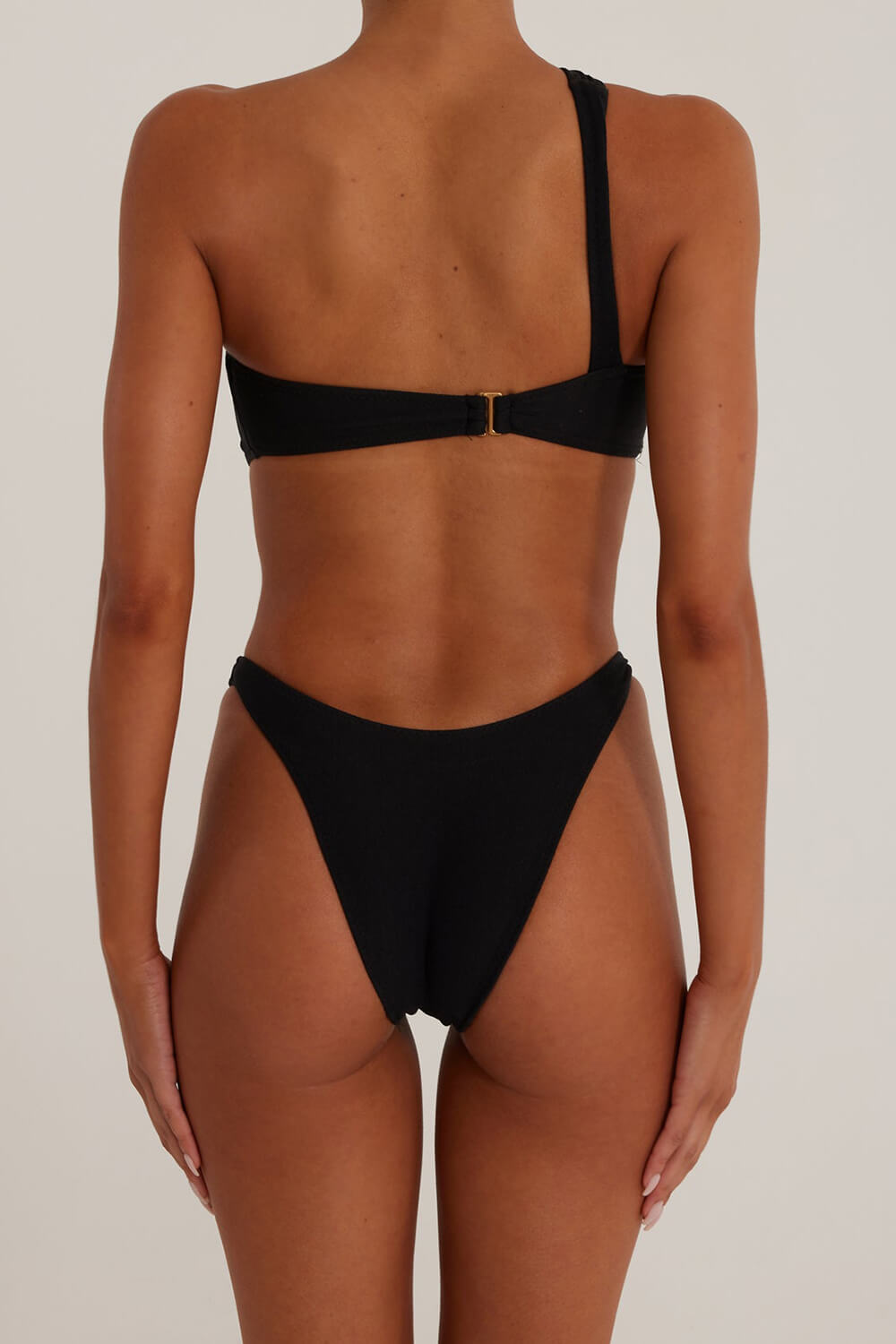 Black One Shoulder One Piece Swimsuit With Gold Spiral Hardware Details